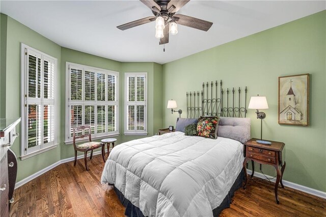 bedroom with baseboards, wood finished floors, and ceiling fan