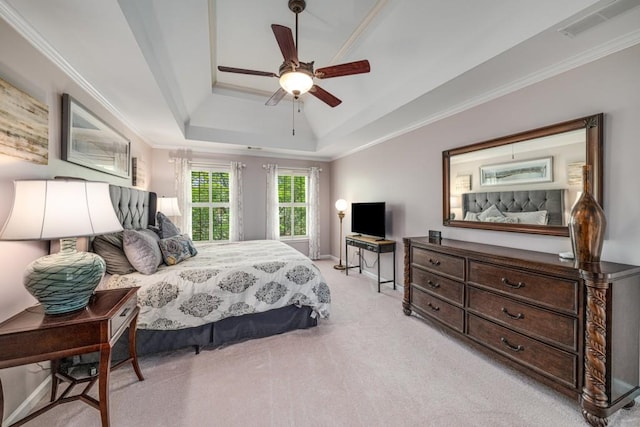 bedroom with a tray ceiling, carpet, crown molding, a ceiling fan, and baseboards