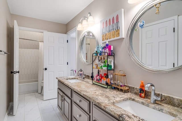 bathroom with marble look tiles, double vanity, and shower / bath combo