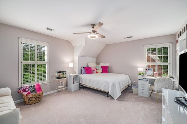 bedroom featuring light colored carpet, a ceiling fan, baseboards, and lofted ceiling