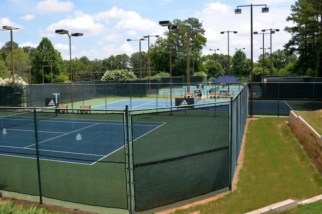 view of tennis court featuring fence