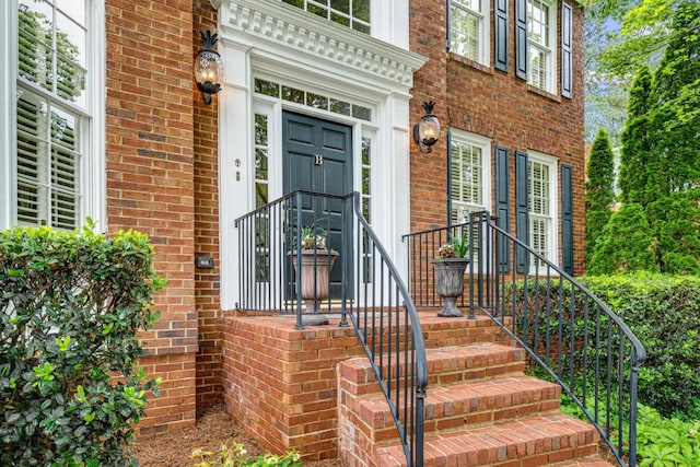 entrance to property featuring brick siding