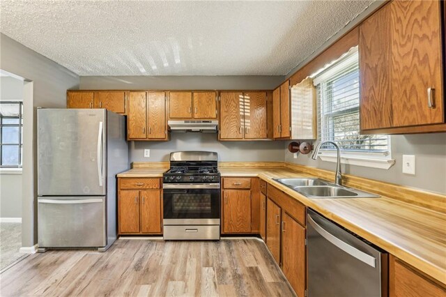 interior space featuring hardwood / wood-style flooring, vanity, and a textured ceiling