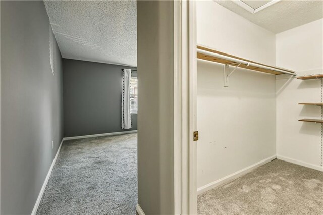 spacious closet featuring dark carpet