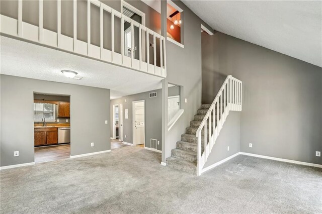 interior space featuring carpet floors and lofted ceiling