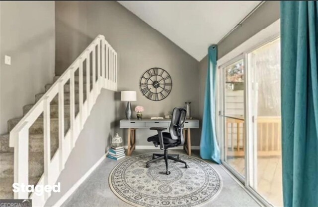 unfurnished living room with carpet, a textured ceiling, a large fireplace, and lofted ceiling