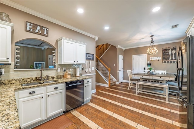 kitchen with backsplash, visible vents, crown molding, a sink, and black appliances