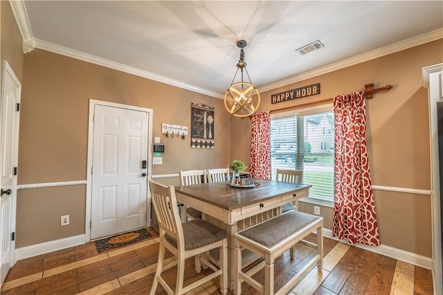 dining room featuring wood-type flooring, baseboards, visible vents, and ornamental molding