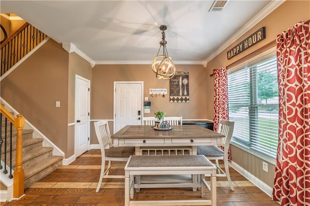 dining room with wood-type flooring, ornamental molding, a healthy amount of sunlight, and stairway