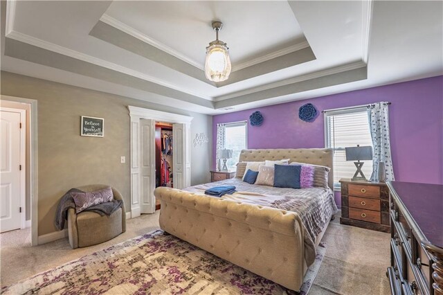 bedroom featuring light colored carpet, a raised ceiling, crown molding, and multiple windows