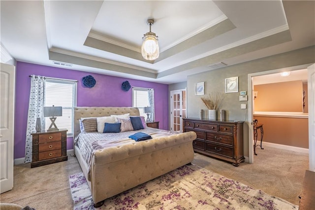 bedroom with carpet floors, a raised ceiling, baseboards, and visible vents