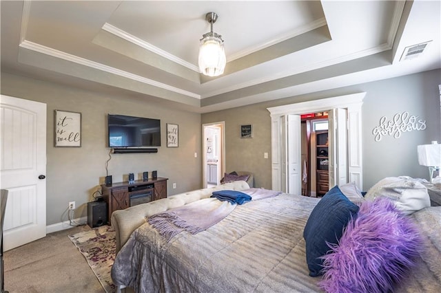 carpeted bedroom featuring a raised ceiling, ornamental molding, and visible vents
