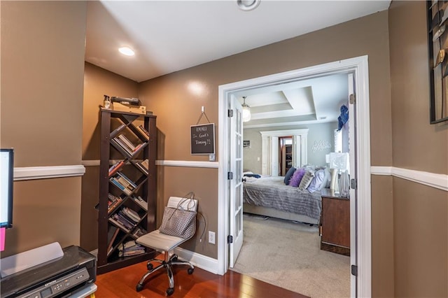 home office featuring baseboards, french doors, and wood finished floors
