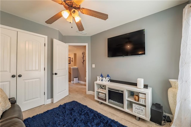carpeted bedroom featuring baseboards, ceiling fan, and a closet