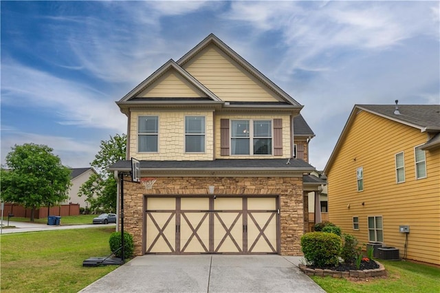 craftsman-style home with a garage, a front lawn, driveway, and stone siding