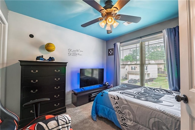 bedroom with baseboards, ceiling fan, and carpet