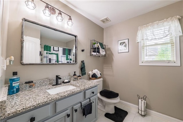bathroom featuring visible vents, tile patterned floors, baseboards, vanity, and toilet