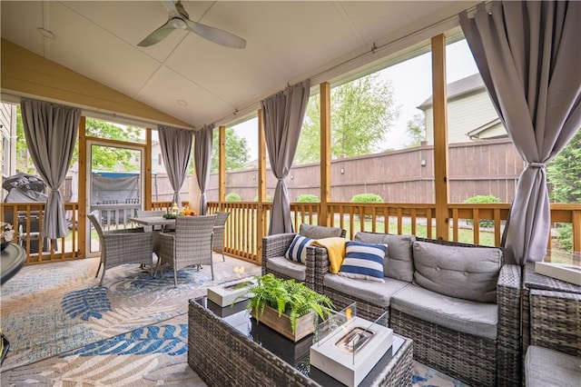 sunroom with plenty of natural light, a ceiling fan, outdoor dining space, and an outdoor living space