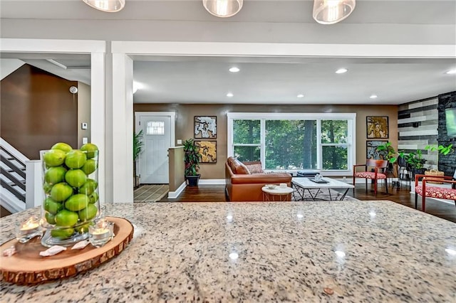 interior space featuring recessed lighting, wood finished floors, and light stone countertops