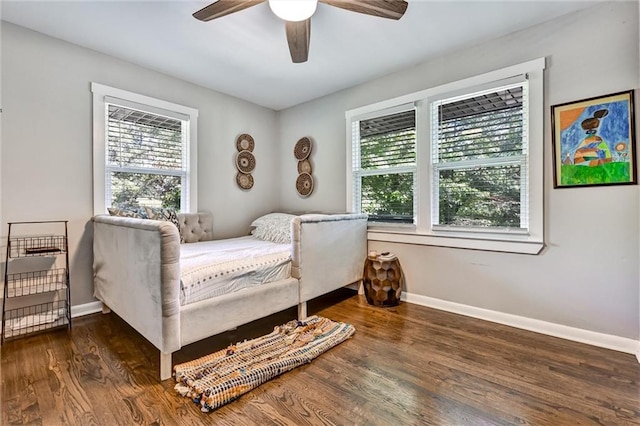 bedroom featuring ceiling fan, wood finished floors, and baseboards