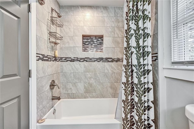 full bath featuring shower / bath combo with shower curtain and toilet