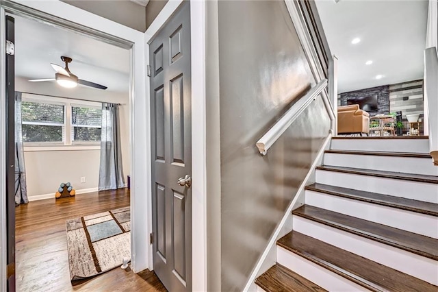 staircase with recessed lighting, wood finished floors, a ceiling fan, and baseboards