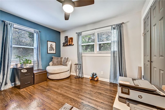 sitting room featuring ceiling fan, baseboards, and wood finished floors