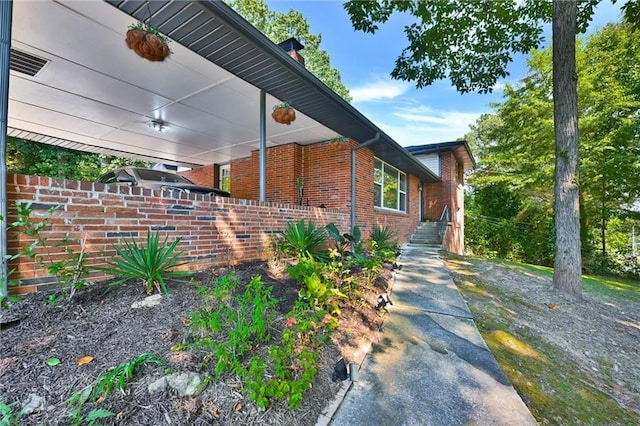 view of home's exterior featuring fence and brick siding