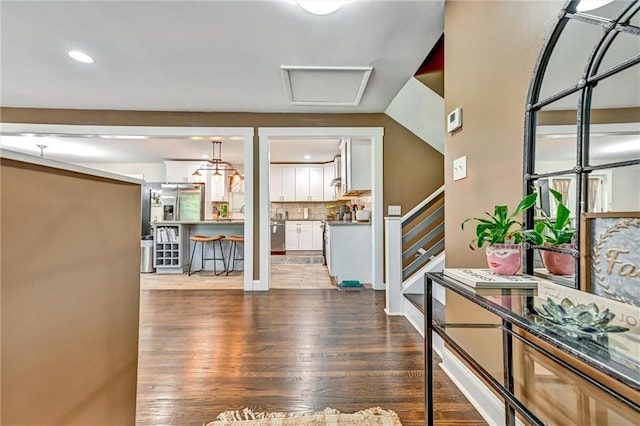 entrance foyer with stairs and wood finished floors