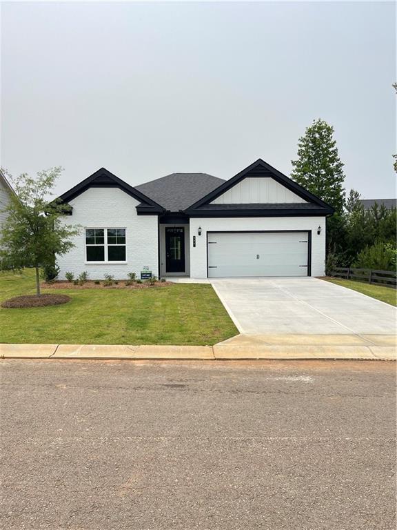 111 Ginger Trl, Homer, GA 30547 - view of front of home with a front yard, an attached garage, and concrete driveway