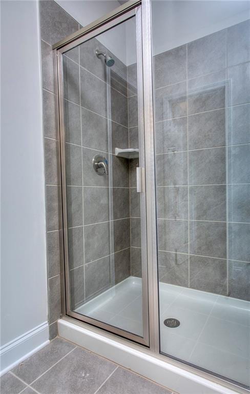 111 Ginger Trl, Homer, GA 30547 - bathroom featuring tile patterned flooring, a shower stall, and baseboards