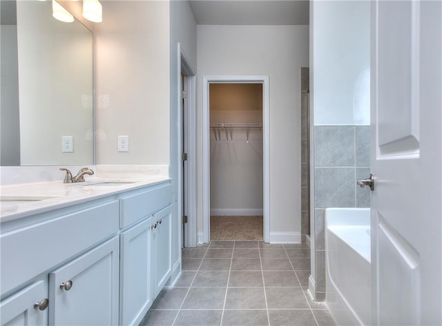 111 Ginger Trl, Homer, GA 30547 - bathroom featuring double vanity, a tub, tile patterned flooring, and a walk in closet