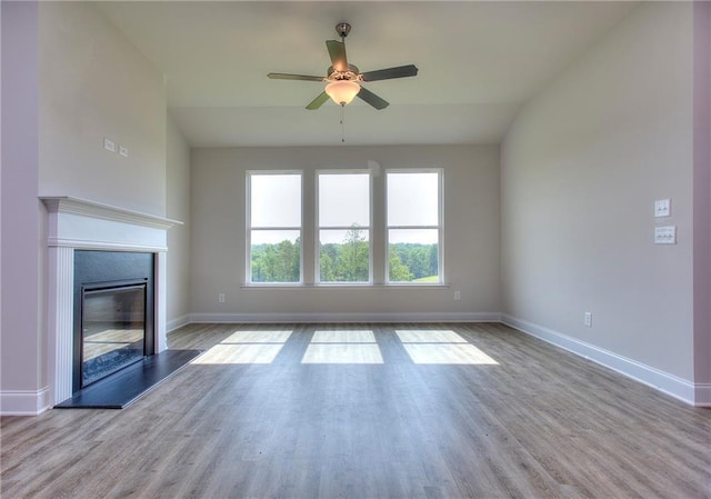 111 Ginger Trl, Homer, GA 30547 - unfurnished living room featuring a ceiling fan, baseboards, wood finished floors, and a glass covered fireplace