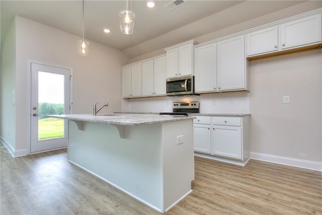 111 Ginger Trl, Homer, GA 30547 - kitchen with appliances with stainless steel finishes, light wood finished floors, an island with sink, baseboards, and white cabinetry