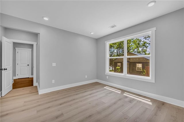 unfurnished room with light hardwood / wood-style flooring