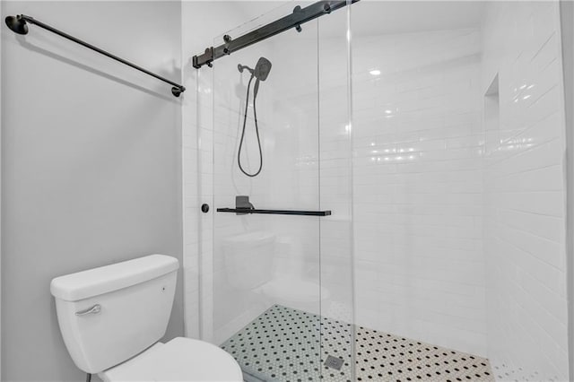 bathroom featuring an enclosed shower and toilet