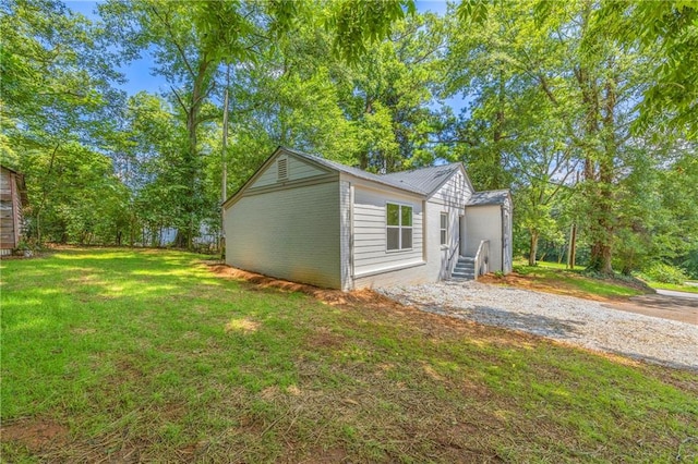 view of side of home with a yard