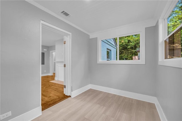 empty room featuring crown molding