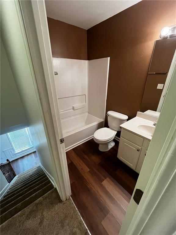 3613 Tinsley Way SW, Atlanta, GA 30331 - bathroom featuring vanity, toilet, wood finished floors, and shower / bathtub combination