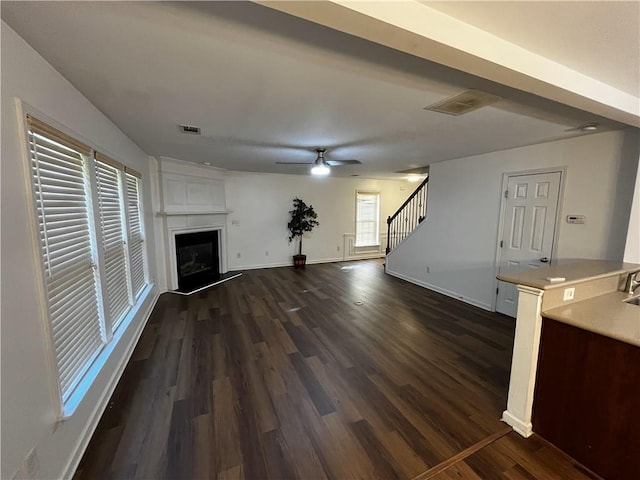 3613 Tinsley Way SW, Atlanta, GA 30331 - unfurnished living room with stairway, dark wood-type flooring, baseboards, a fireplace, and ceiling fan