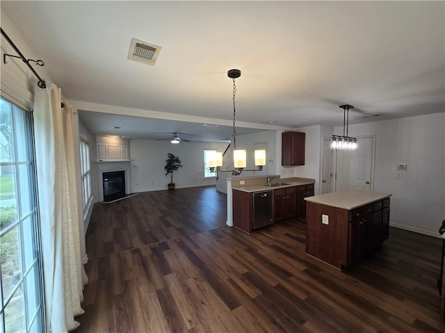 3613 Tinsley Way SW, Atlanta, GA 30331 - kitchen with a sink, dishwasher, light countertops, dark wood finished floors, and a glass covered fireplace