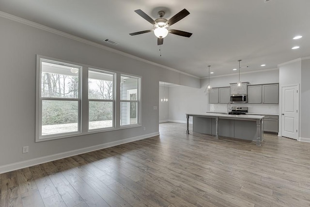 199 Montview Dr, Jefferson, GA 30549 - kitchen with stainless steel appliances, light countertops, visible vents, gray cabinetry, and a kitchen island with sink