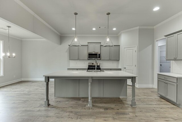 199 Montview Dr, Jefferson, GA 30549 - kitchen featuring appliances with stainless steel finishes, a breakfast bar, gray cabinets, and light countertops