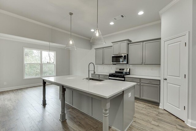 199 Montview Dr, Jefferson, GA 30549 - kitchen with a center island with sink, stainless steel appliances, light countertops, gray cabinetry, and a sink