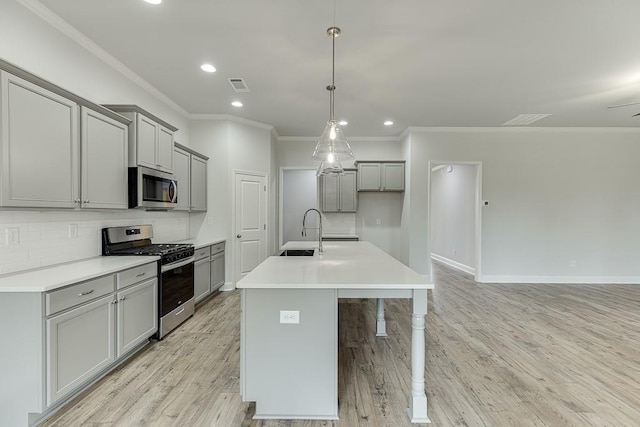 199 Montview Dr, Jefferson, GA 30549 - kitchen with visible vents, an island with sink, appliances with stainless steel finishes, hanging light fixtures, and light countertops
