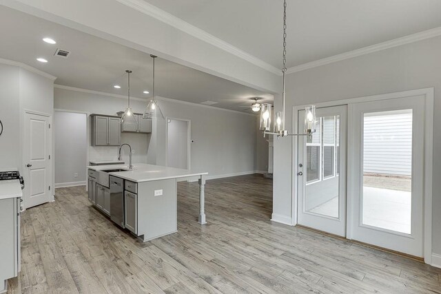 199 Montview Dr, Jefferson, GA 30549 - kitchen with gray cabinets, light countertops, a center island with sink, and hanging light fixtures