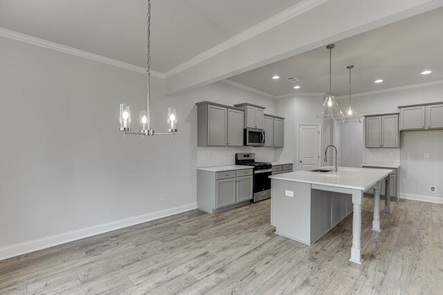 199 Montview Dr, Jefferson, GA 30549 - kitchen featuring decorative light fixtures, stainless steel appliances, gray cabinets, light countertops, and a kitchen island with sink