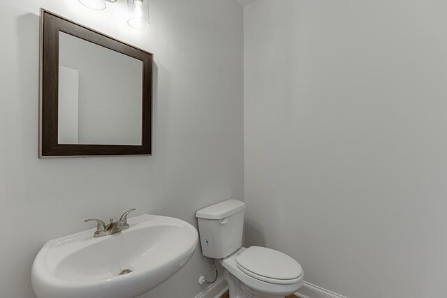 199 Montview Dr, Jefferson, GA 30549 - half bath with baseboards, a sink, and toilet