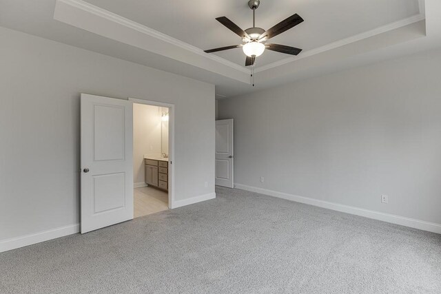 199 Montview Dr, Jefferson, GA 30549 - unfurnished bedroom featuring ornamental molding, a tray ceiling, light carpet, and baseboards