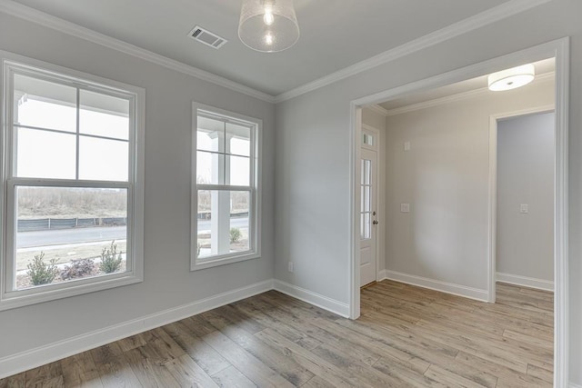 199 Montview Dr, Jefferson, GA 30549 - unfurnished room with crown molding, visible vents, plenty of natural light, and light wood finished floors